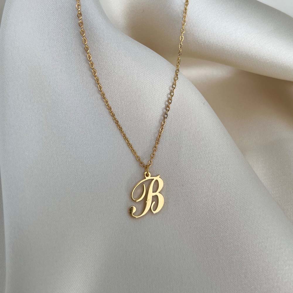 Personligt Alora Letter Necklace med bokstaven B i skrivstil, perfekt för att lägga till en unik detalj till din stil.