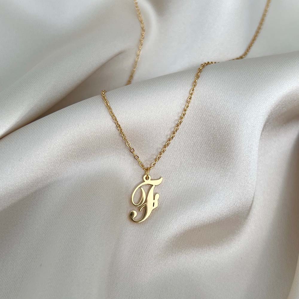 Personligt Alora Letter Necklace med bokstaven F i skrivstil, designat för hållbarhet och elegans i alla miljöer.