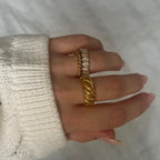 Classic Croissant Ring från Alora Avenue stylad i en elegant ringstack med gnistrande detaljer och chunky texturer. En vattentålig, allergivänlig guldring som ger lyxig känsla även i vardagens mjukaste stunder – perfekt för dig som vill bära stil med själ och värme.