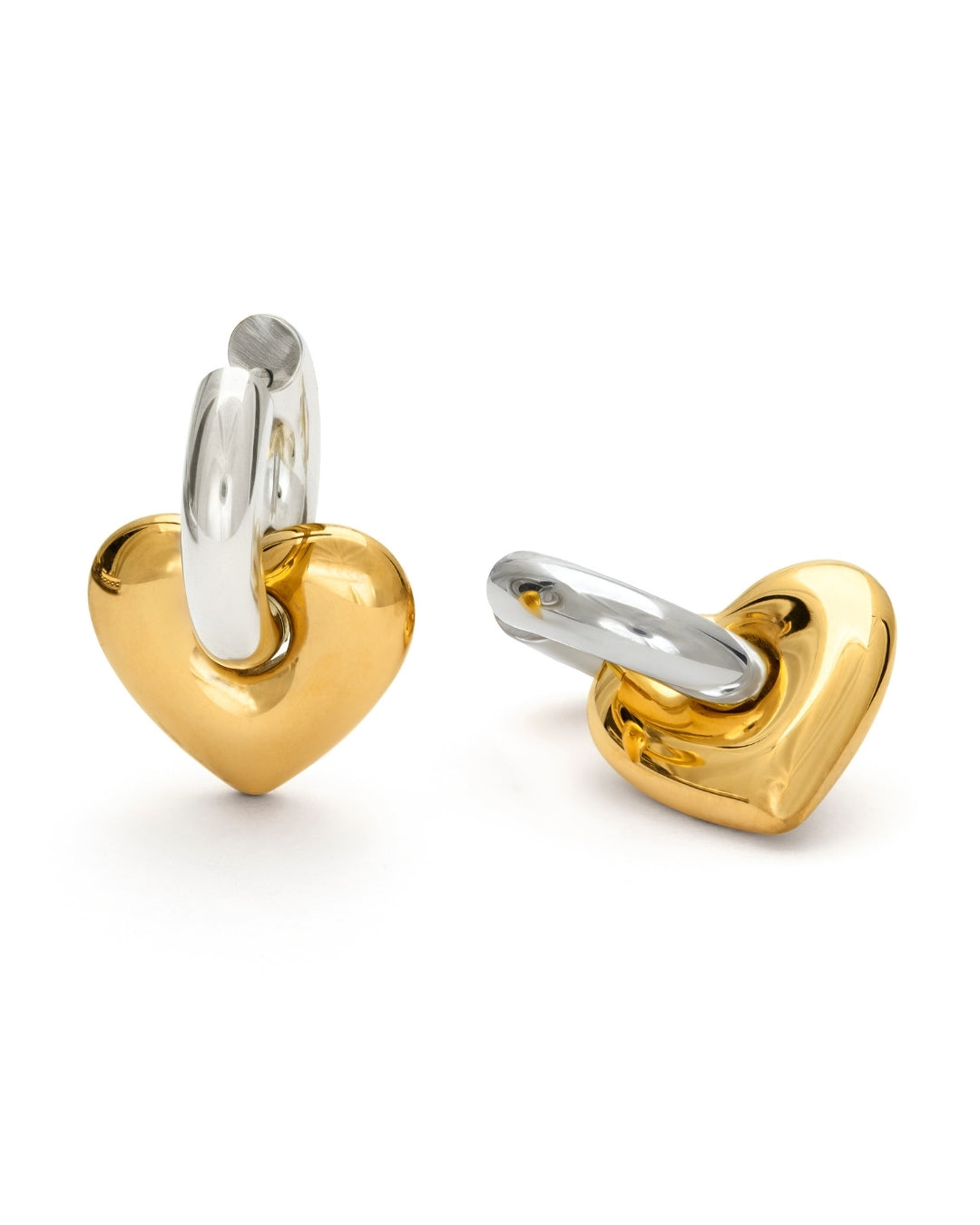 Eleganta Lydia Love Loops örhängen med en silvrig hoop och guldigt hjärta. Tillverkade i vattentåligt, allergivänligt stål med PVD-beläggning – perfekta från Alora Avenue för både vardag och fest.