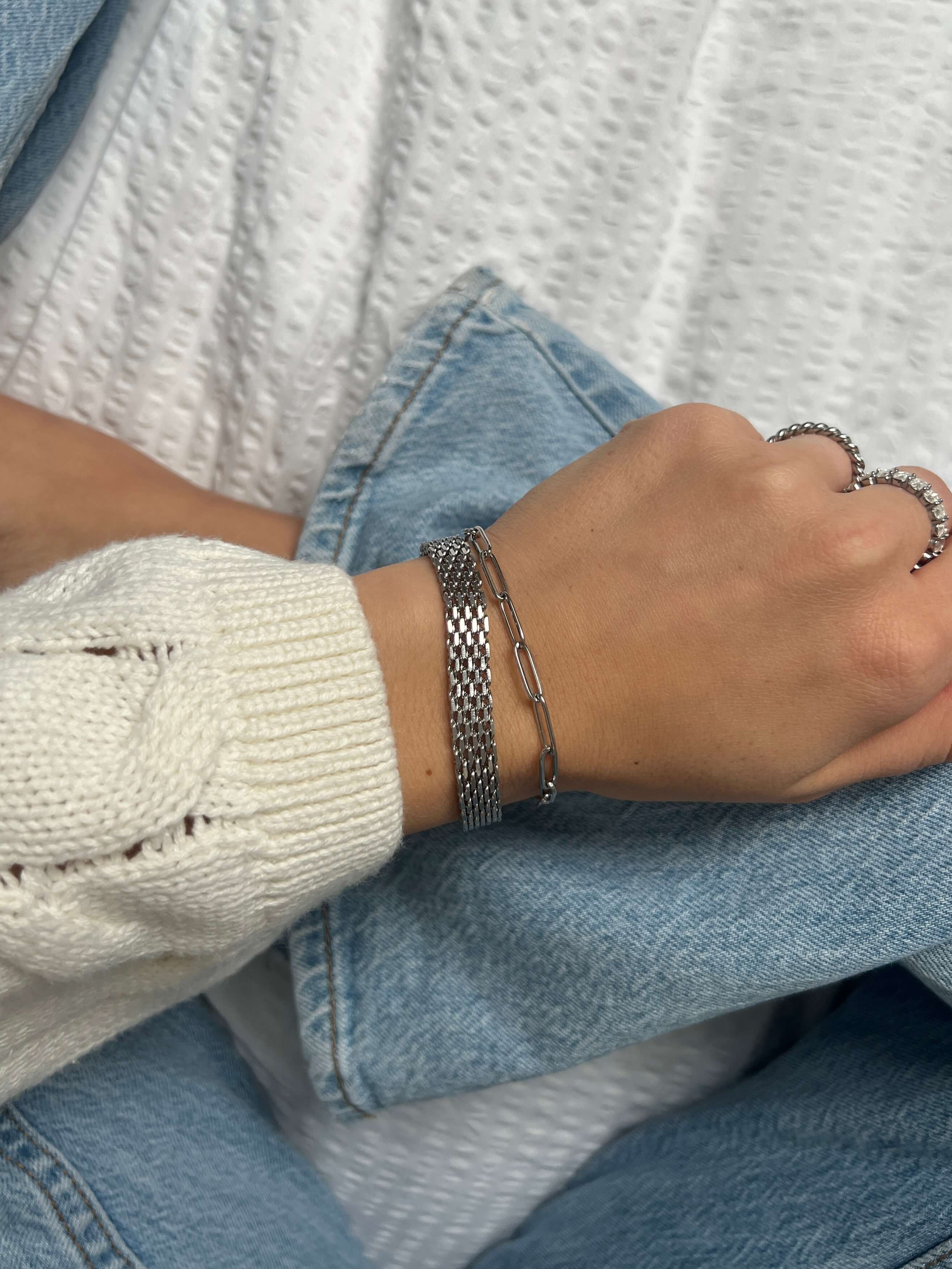 Lucid Clip Bracelet – stilrent silverarmband med paperclip-länkar, perfekt för lager-på-lager-look, fotograferat på handled med stickad tröja och denim från Alora Avenue