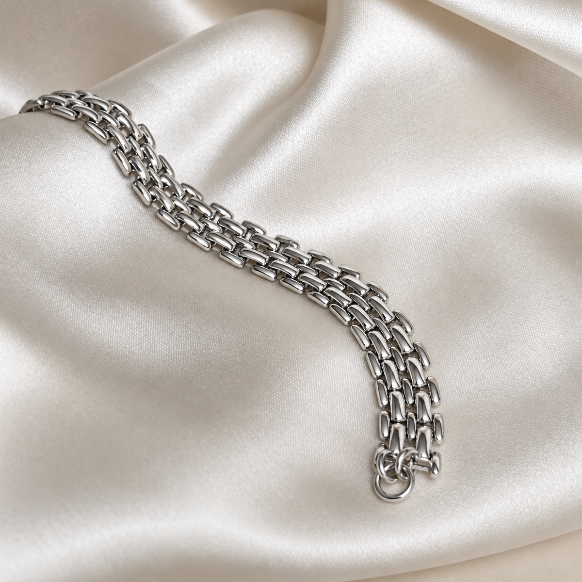 Mia Magnolia Bracelet i silver fotograferat på ljust silkestyg. Vattentåligt och allergivänligt armband i rostfritt stål från Alora Avenue.
